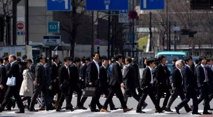 Shibuya scramble crossing in the morning is crowded with people going to work in Japan.