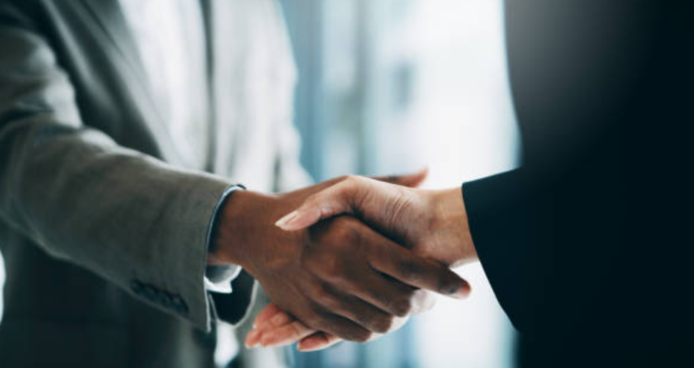 A handshake seals the deal on an employment contract in Japan.