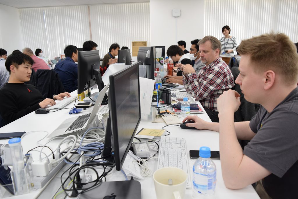 An office in Tokyo with many foreign software engineers working